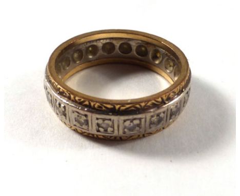 A yellow and white metal full eternity ring set small diamonds in a scrollwork setting, ring size M, 5.6 gms 