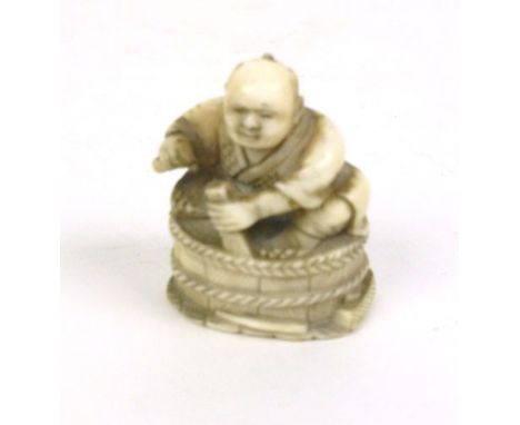 A Japanese ivory netsuke in the form of a barrel maker, h. 4 cm