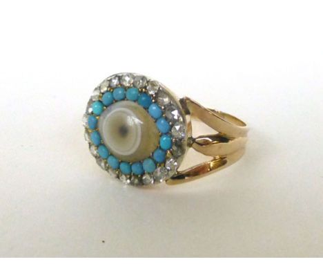 A 19th century yellow gold ring, the oval glass in the form of an eye within a border of turquoise and rose cut diamonds, set