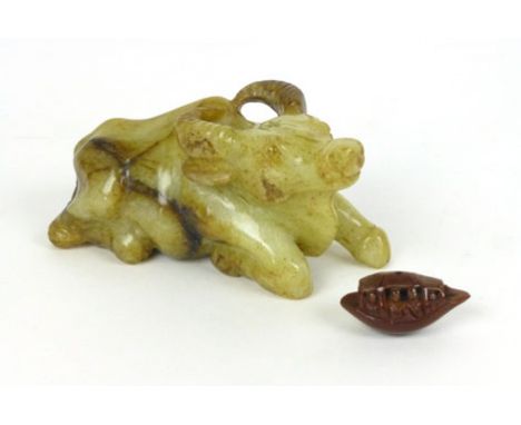 An early 20th century Chinese Jade style hard stone figure modeled as a water buffalo, together with small netsuke modeled as