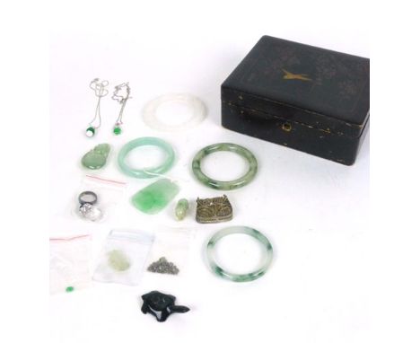 An Oriental black lacquered box containing a selection of various jade, jadite and white metal Chinese jewellery to include f