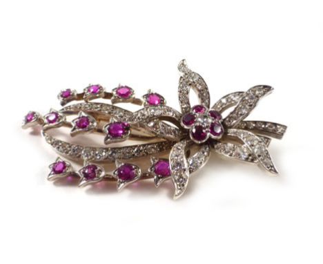 A yellow gold and platinum highlighted 'en tremblant' brooch in the form of a floral spray set diamonds and rubies, estimated