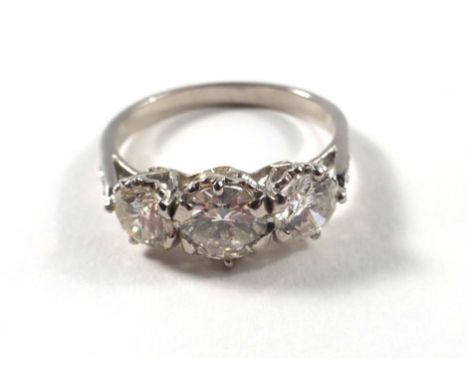 A white gold ring set three graduated diamonds in an openwork heart shaped setting, estimated total diamond weight approximat