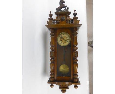A Vienna style walnut and beech cased wall clock, the face with Roman numerals and pierced hands, h. 125 cm, w. 45 cm  CONDIT
