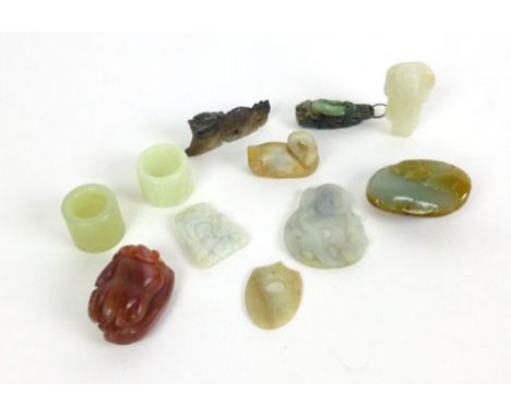 A group of eleven Chinese jade and agate carvings to include a Buddha hand, a white boy holding a lotus etc.