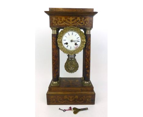 An early 19th century rosewood, marquetry and brass mounted eight day mantle clock, with four columns flanking the enameled f