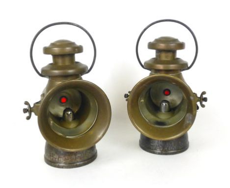 A pair of Lucas 'King of the Road' oil burning vehicle lamps marked 742, with looped handle, ruby glass tell-tale lens,  h. 3