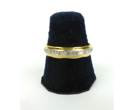 A 22ct two colour wedding band with engraved decoration, ring size P, 4.3 gms 