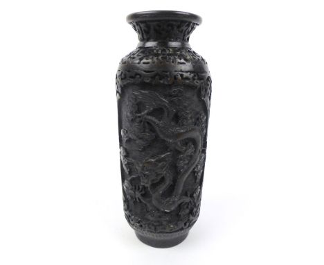 A Chinese cylindrical two-panel vase relief carved with dragons within foliate panels, h. 20 cm


