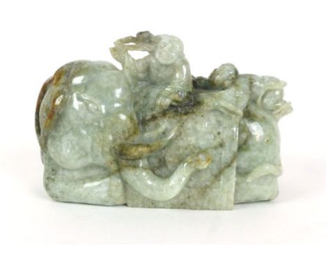 A 20th century Chinese jade figure modelled as an elephant with two boys on his back, h. 10 cm