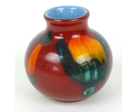 A Poole Pottery Delphis range vase of squat form, the red ground decorated with orange and blue patterns, h. 10 cm CONDITION 