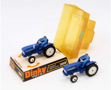 2 Dinky Toys No. 308 Leyland 384 Tractor, both have a blue body, with white hubs, and driver figure, one comes in the origina