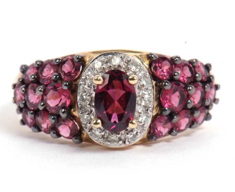 Modern 9ct gold pink stone and diamond ring, the centre pink stone raised within a small diamond surround, the shoulders deco