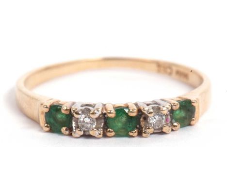 Modern emerald and diamond ring, line set with three small emeralds and two small diamonds, stamped 14kt, size M