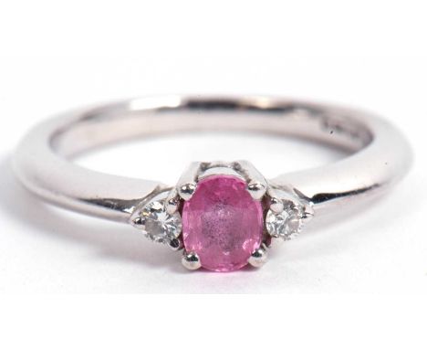 18ct gold white and pink sapphire and diamond three stone ring centering an oval faceted pink sapphire flanked by two small r