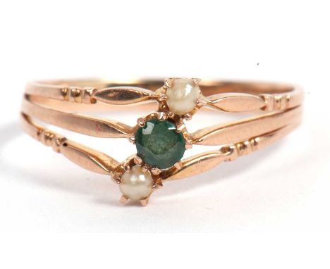 Emerald and pearl ring design featuring three bands, the centre band highlighted with a small round cut faceted emerald betwe