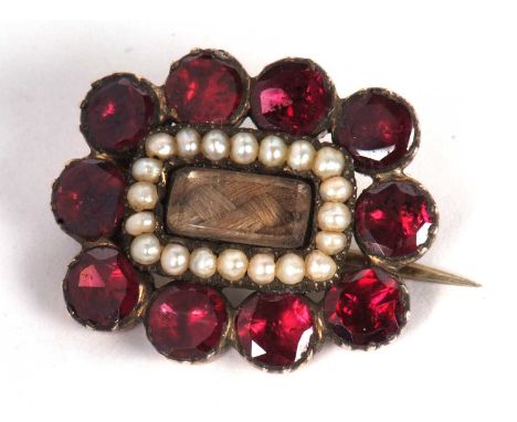Antique mourning brooch the centre glazed panel with plaited hair framed within seed pearl surround, further framed by ten ro