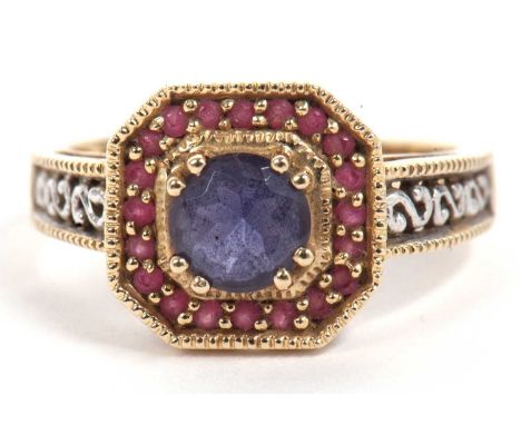 Modern 9ct gold blue and red stone dress ring, the round faceted blue centre stone raised within a red stone surround between