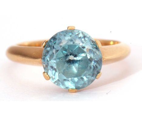 Single blue zircon stone ring, the round faceted zircon, 9mm diameter, raised between upswept shoulders in a plain polished m