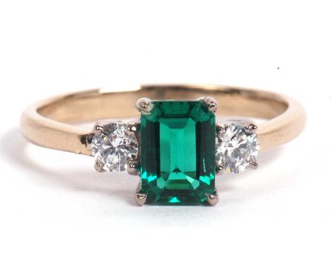 Green stone and diamond ring the central step cut green stone flanked by two brilliant cut diamonds of 0.15ct each app, size 