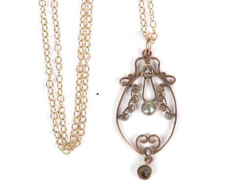 Open work pendant highlighted with seed pearls and peridots, stamped 9ct and suspended from a 375 marked chain