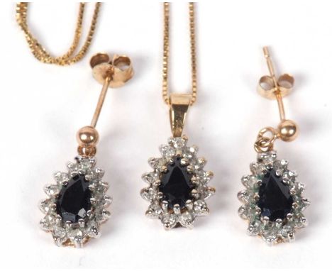 9ct gold sapphire and diamond pendant with matching earrings, with post fittings, each centering a pear shaped dark sapphire,