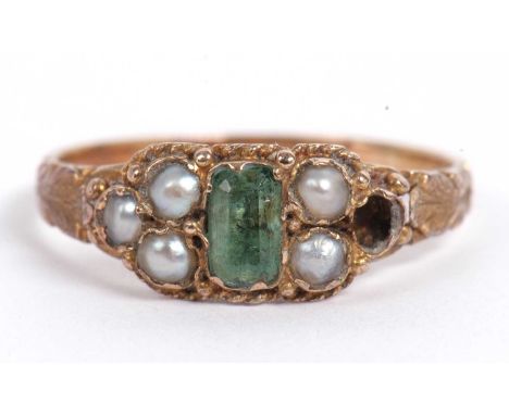 Antique Emerald and seed pearl ring, the stepped emerald framed in a bead and leaf setting and highlighted with five small se