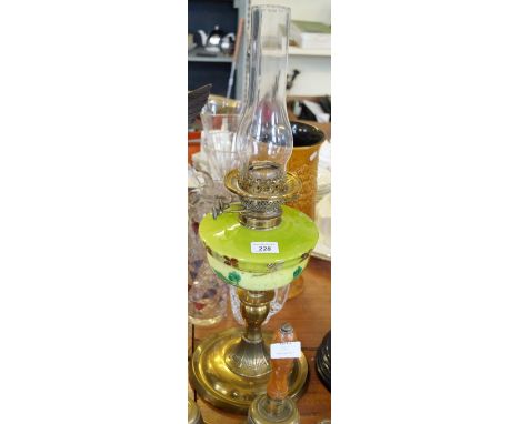An early to mid 20th Century oil lamp with green glass reservoir.