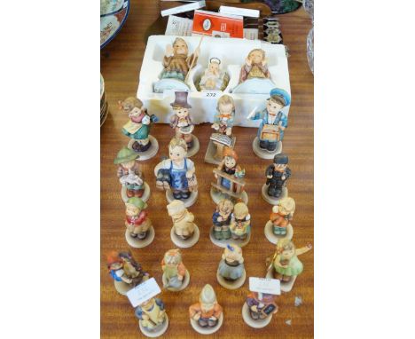 A large collection of assorted Goebal Hummel figures and souvenir spoons.