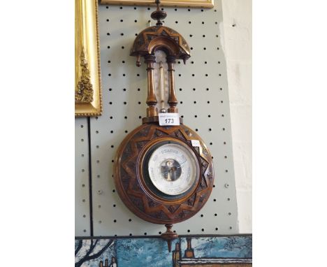 An Edwardian carved walnut barometer.