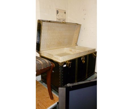 A vintage brass bound storage trunk.