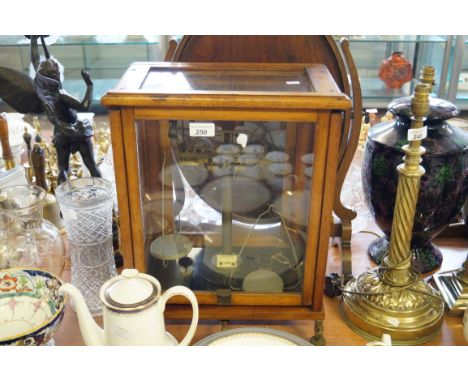 A mahogany cased set of scientific balance scales.