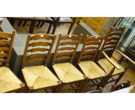 A set of six rush seated ladder back dining chairs.