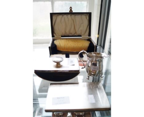 A mixed of items to include a Birmingham hallmarked silver rectangular cigarette case, a silver cream jug raised on three hoo
