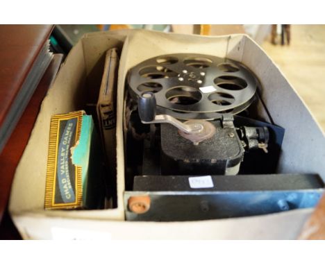A vintage cine projector and two reels.