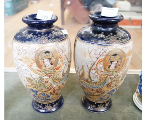 A pair of oriental ceramic vases of baluster form depicting figures on a cobalt blue ground  