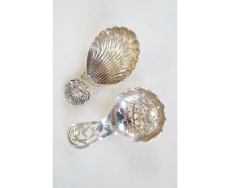 Two hallmarked silver caddy spoons to include one with conch shell decoration 
