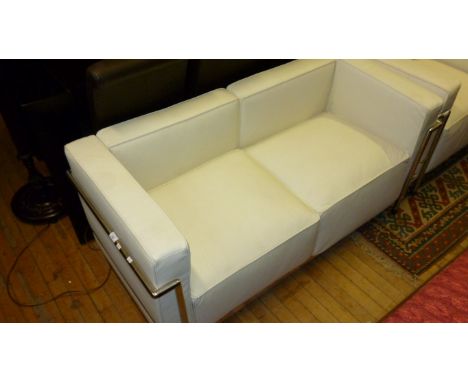 A modern two seater white Le Corbusier sofa