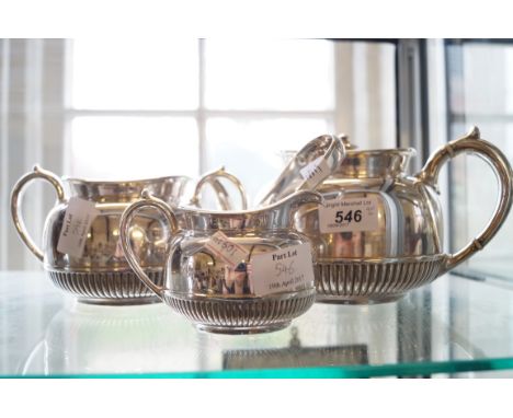 A silver-plated three piece tea service with fluted decoration together with a pair of Georgian hallmarked silver sugar tongs