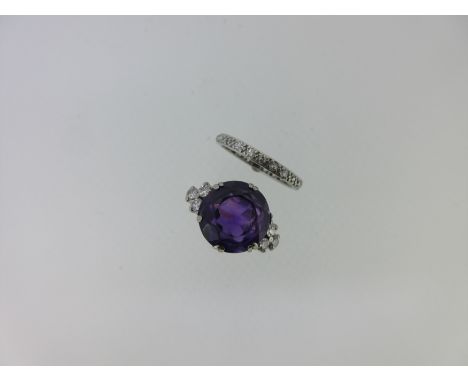 the first with a 12mm round cut vivid purple amethyst double claw set between trefoils of round brilliant cut diamonds, cage 