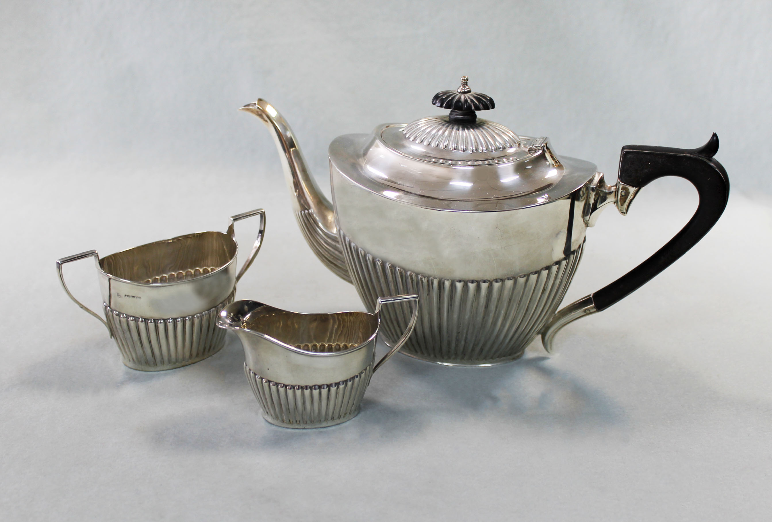 A V silver teapot, with milk jug and sugar bowl, in