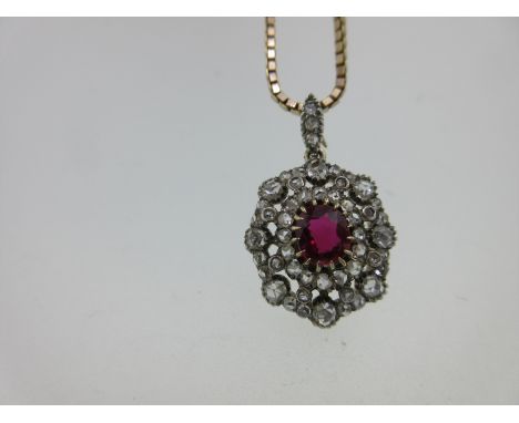 the open cluster centred on an oval cut ruby within a fancy double border of rose cut diamonds, removable bale set with three