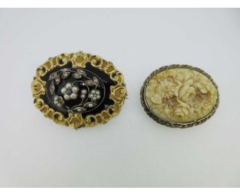 the first an oval memorial brooch with raised central plaque of black enamel overset with arching stems and flowers set with 