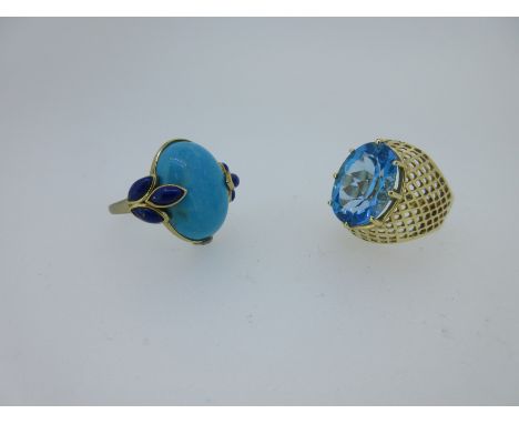 the first set with a large oval cut London blue topaz, claw set in a bombé pierced gold mesh tapering into the polished shank