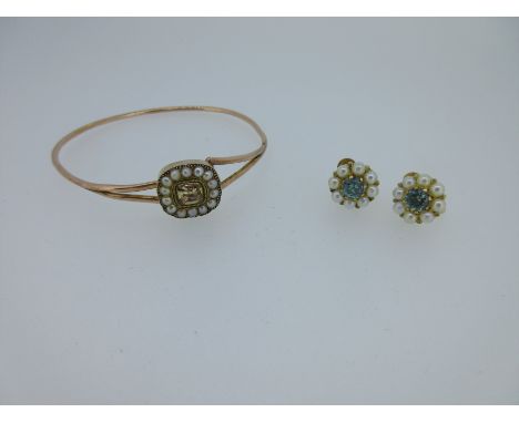 the cushion cut light orange-brown topaz in a gas pipe mount with border of seed pearls, closed back slightly concave setting