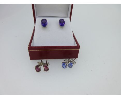 all the stones oval cut and four claw set, lengths - amethyst 8mm, tanzanite 6mm, pink tourmaline 6mm, the amethyst pair case