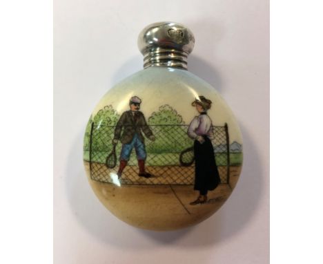 of circular flask shaped form, featuring an image of a gentleman and lady playing tennis, the silver screw off cover by Louis