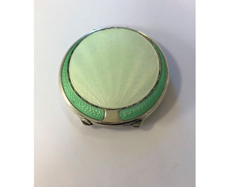 by Joseph Gloster Ltd, Birmingham 1946, of circular form, the hinged cover decorated with waves of pale green guilloché ename