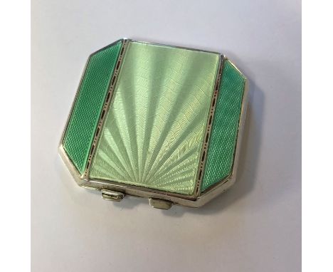 by Joseph Gloster Ltd, Birmingham 1938, of octagonal form, the piano hinged cover decorated with a sunburst of pale green gui