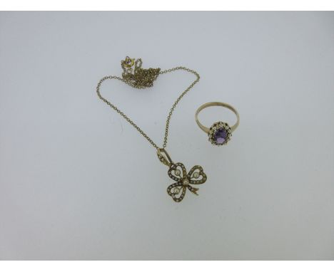 the pendant designed as an open three-leafed clover or shamrock delineated by tiny seed pearls (some damage) and set in the c